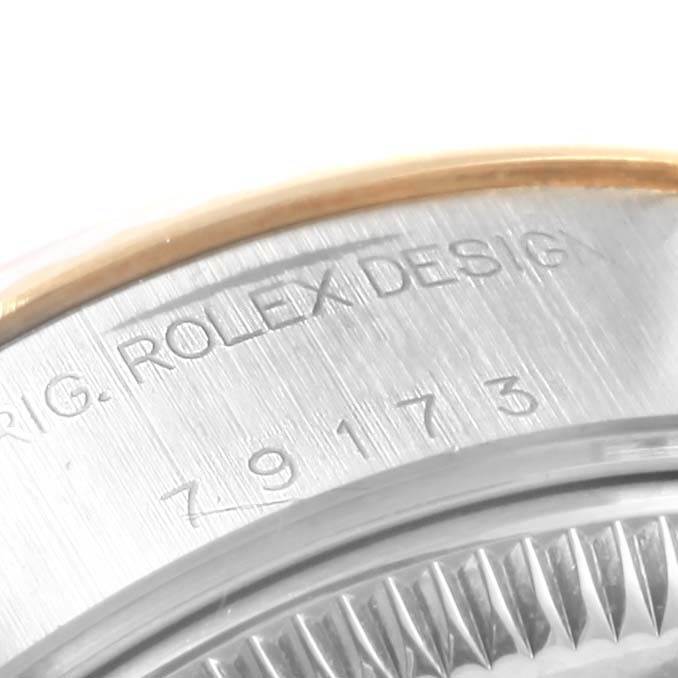 This image shows a close-up of the case back of a Rolex Datejust 79173 Women's Steel and Gold (two tone) Champagne Dial 79173 Women's Steel and Gold (two tone) Champagne Dial watch, highlighting the "ROLEX DESIGN" engraving and part of the model number.