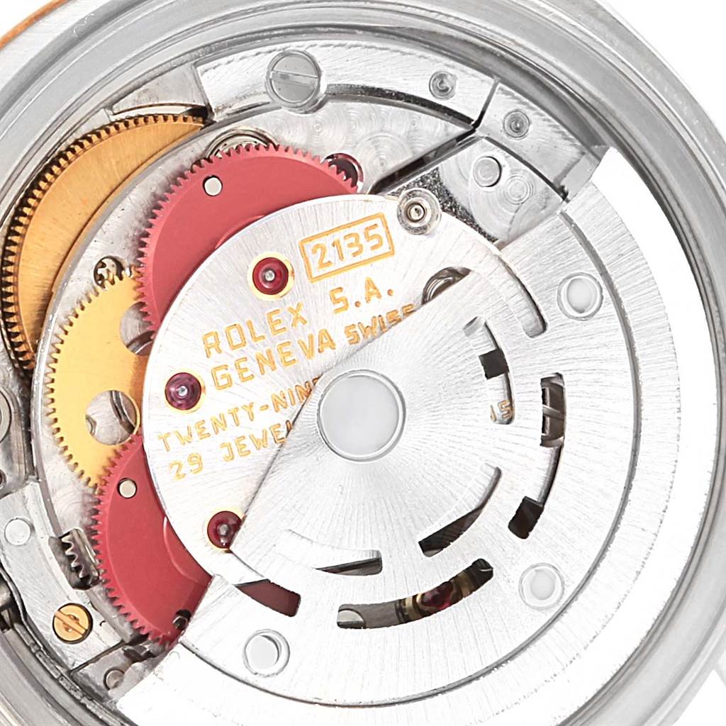 This image shows a close-up of the movement parts of a Rolex Datejust 69173 Women's Stainless Steel White Dial 69173 Women's Stainless Steel White Dial watch, including gears and the rotor.