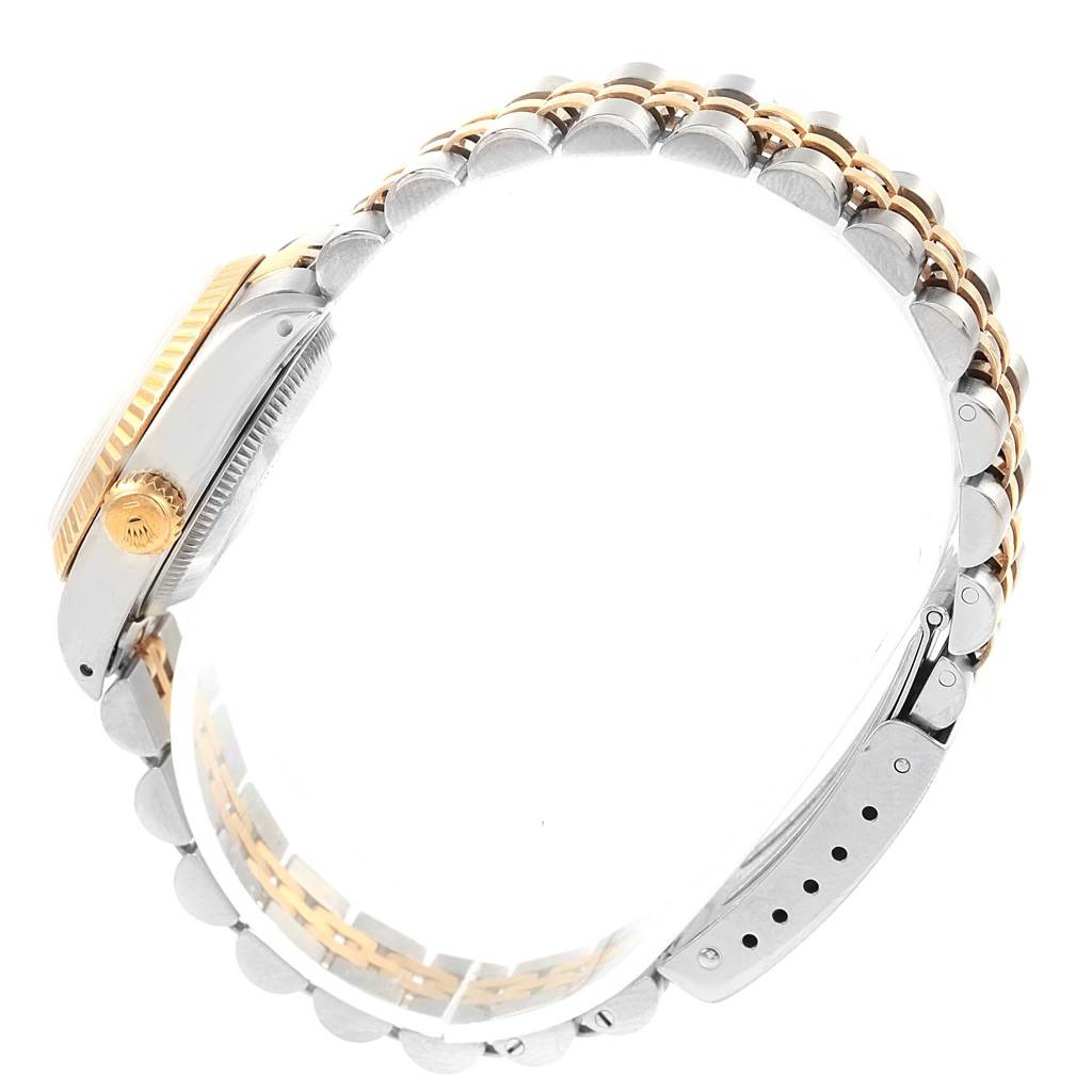The image shows a side view of a Rolex Datejust 69173 Women's Stainless Steel White Dial 69173 Women's Stainless Steel White Dial watch, highlighting its crown and two-tone bracelet.
