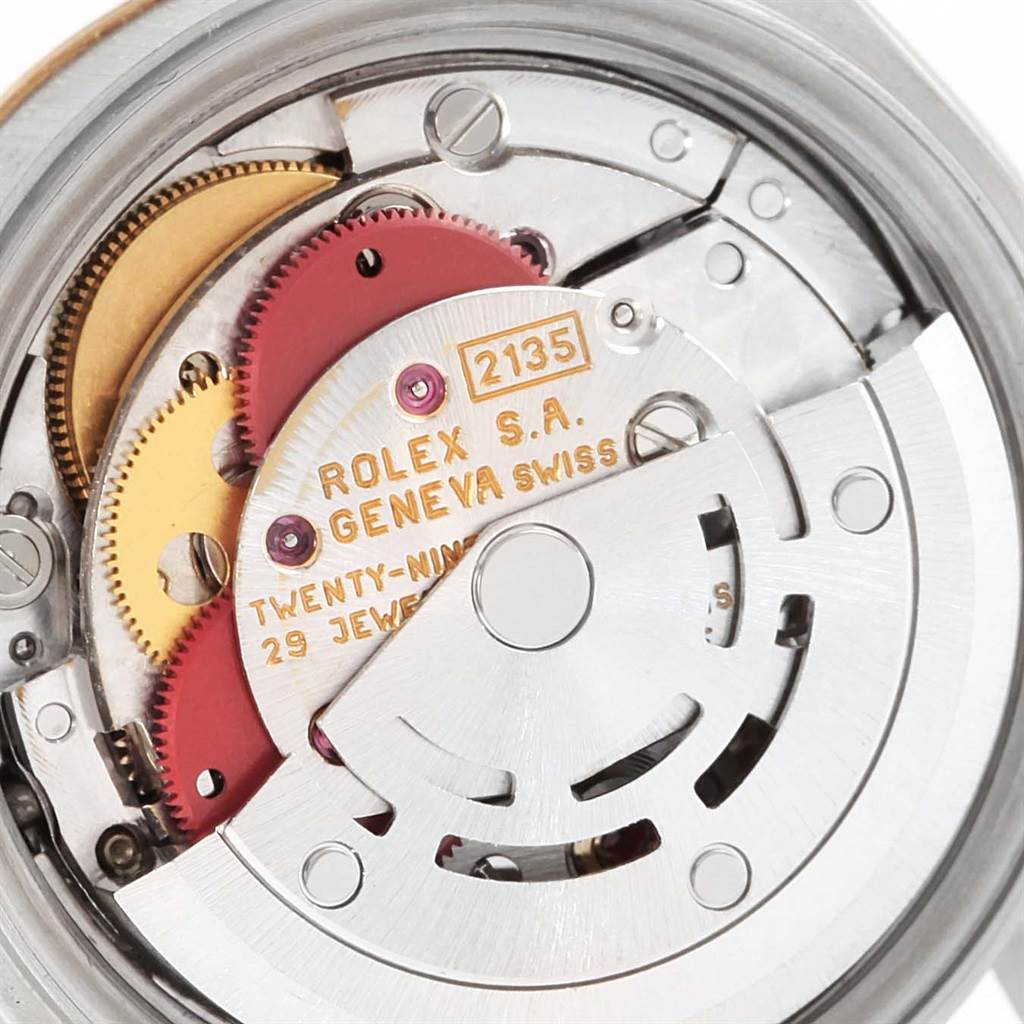 The close-up image shows the movement mechanism of a Rolex Datejust 69163 Women's Stainless Steel Grey Dial 69163 Women's Stainless Steel Grey Dial watch, highlighting gears and the rotor.