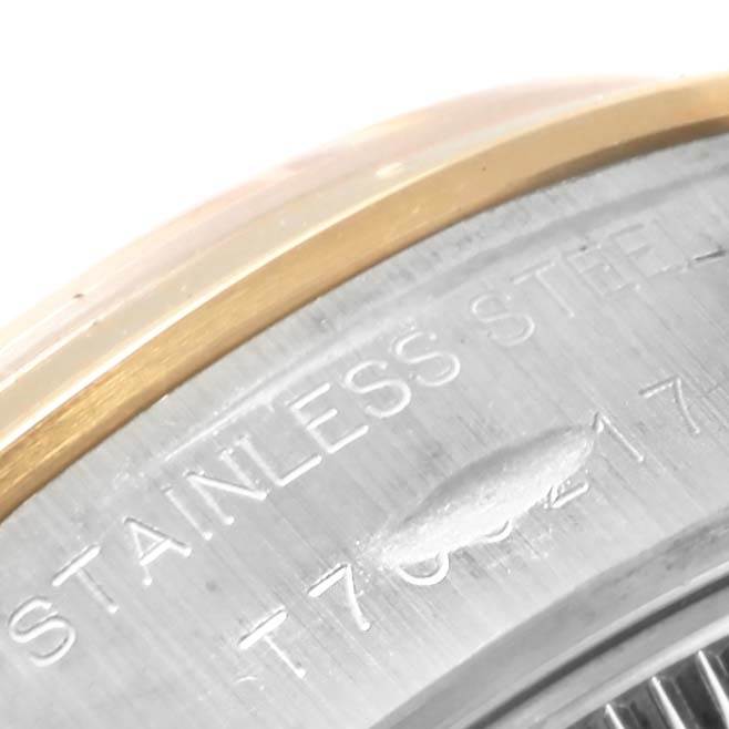 The image shows a close-up of the side of a Rolex Datejust 69163 Women's Stainless Steel Grey Dial 69163 Women's Stainless Steel Grey Dial watch, highlighting its stainless steel and gold bezel.