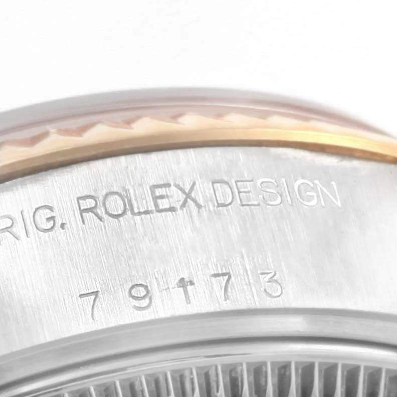 This close-up image shows the side of the case and part of the bezel of a Rolex Datejust 79173 Women's Steel and Gold (two tone) Blue Dial 79173 Women's Steel and Gold (two tone) Blue Dial watch.