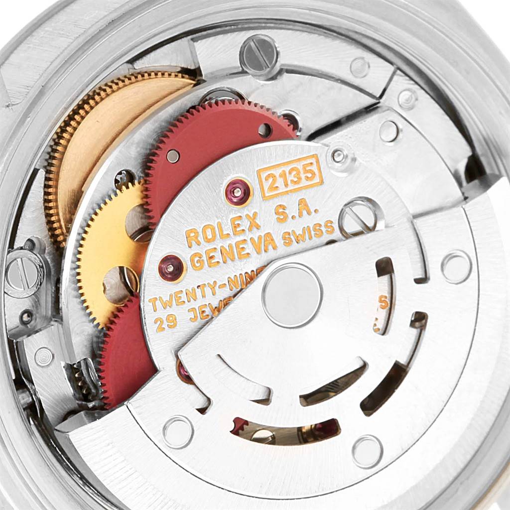 The image shows the internal movement mechanism of a Rolex Datejust 69174 Women's Stainless Steel White Dial 69174 Women's Stainless Steel White Dial watch, highlighting the gears and inscription.