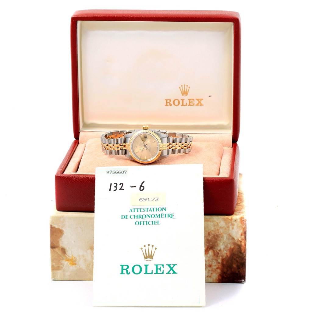 The Rolex Datejust 69173 Women's Stainless Steel Champagne Dial 69173 Women's Stainless Steel Champagne Dial watch is shown in its open box with accompanying documentation in the foreground.