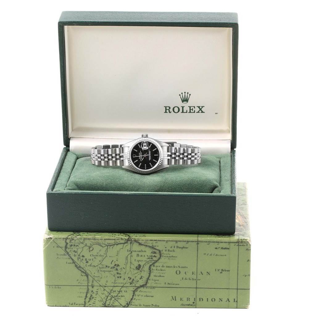 This image shows a Rolex Datejust 69174 Women's Stainless Steel Black Dial 69174 Women's Stainless Steel Black Dial watch from the front, placed inside an open green Rolex box.