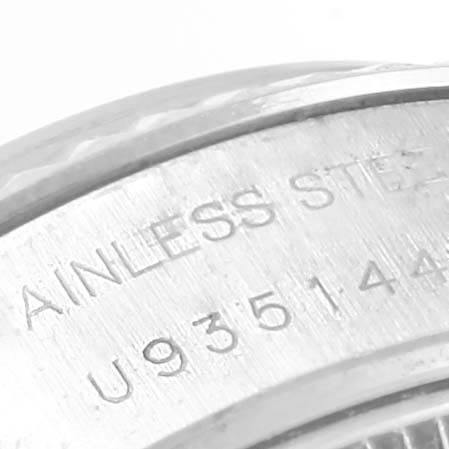 This image shows a close-up of the serial number and part of the stainless steel case back of a Rolex Datejust 69174 Women's Stainless Steel Black Dial 69174 Women's Stainless Steel Black Dial watch.