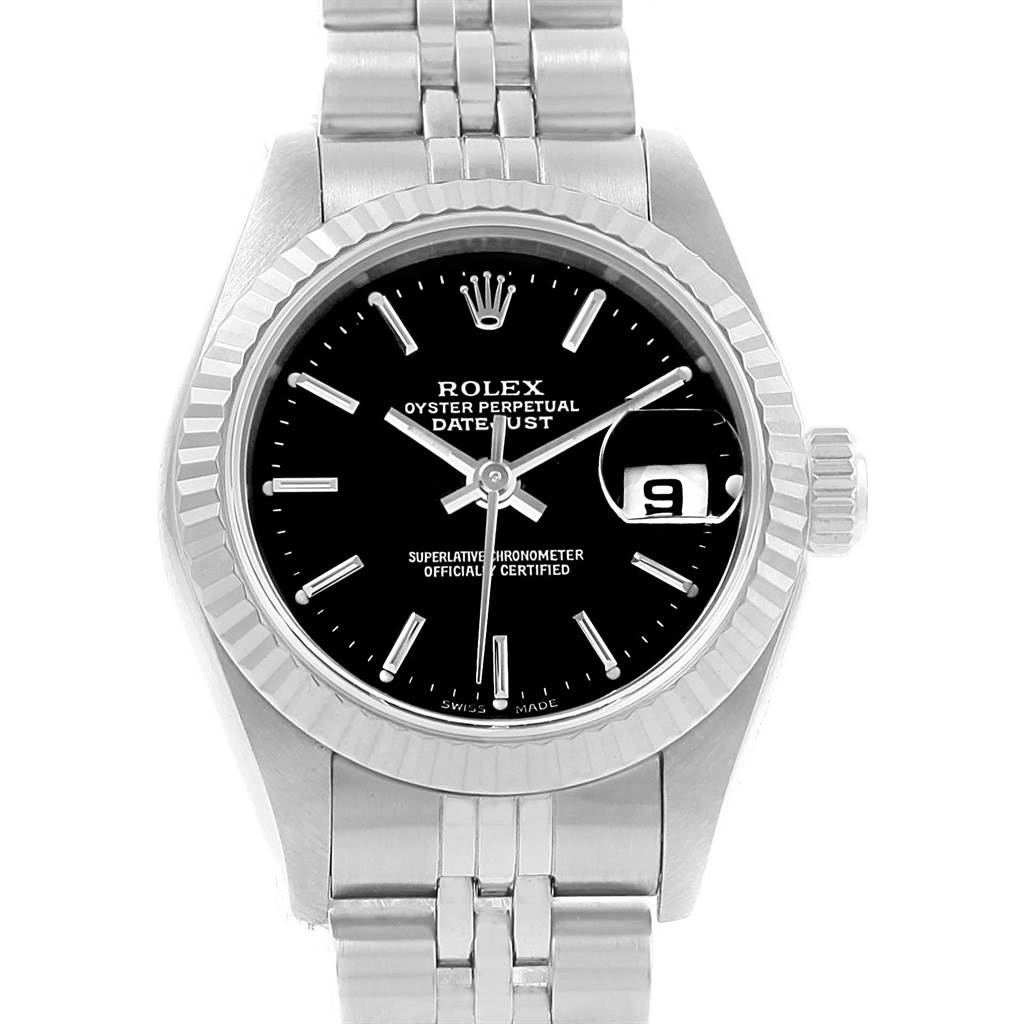 The image shows a frontal view of a Rolex Datejust 69174 Women's Stainless Steel Black Dial 69174 Women's Stainless Steel Black Dial watch, highlighting its black dial, fluted bezel, bracelet, and date window.