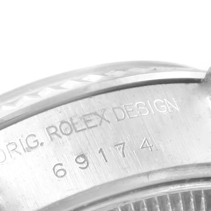 This image shows a close-up view of the model number "69174" and the "ORIG. ROLEX DESIGN" engraving on a Rolex Datejust 69174 Women's Stainless Steel Black Dial 69174 Women's Stainless Steel Black Dial.