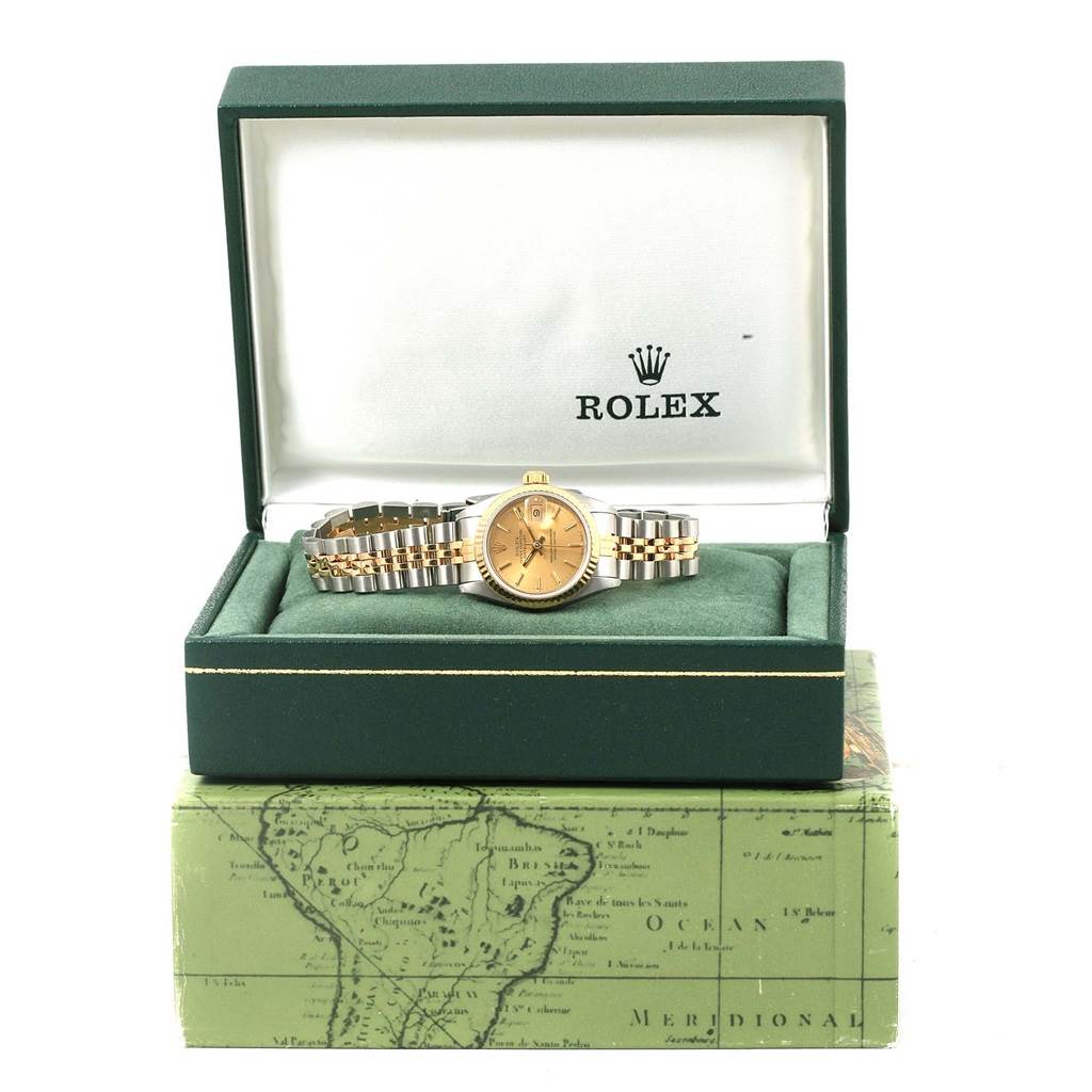 The Rolex Datejust 69173 Women's Stainless Steel Champagne Dial 69173 Women's Stainless Steel Champagne Dial watch is shown from a front angle, displayed inside an open green box with branding visible.