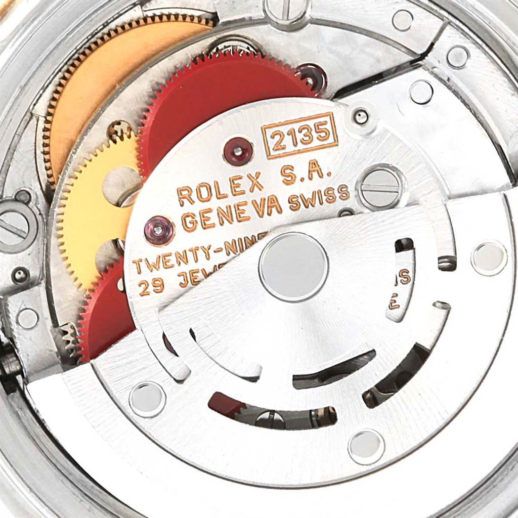The image shows a close-up view of the movement mechanism of a Rolex Datejust 69173 Women's Stainless Steel Champagne Dial 69173 Women's Stainless Steel Champagne Dial watch, specifically showcasing the gears and rotor.