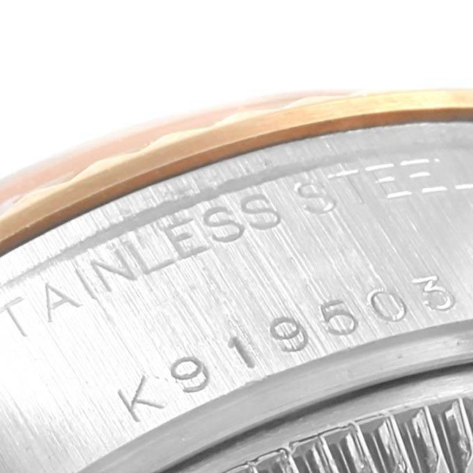 This close-up image of the Rolex Datejust 79173 Women's Steel and Gold (two tone) Champagne Dial 79173 Women's Steel and Gold (two tone) Champagne Dial shows the stainless steel case with part of the serial number engraved.