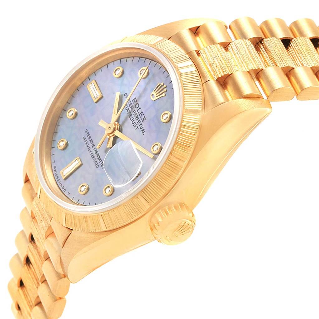 The image shows a side angle of a Rolex Datejust 69278 Women's Yellow Gold Mother of Pearl Dial 69278 Women's Yellow Gold Mother of Pearl Dial watch highlighting its crown, dial, bezel, and band.