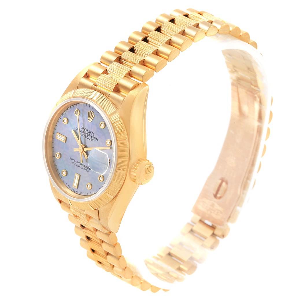 This image shows a Rolex Datejust 69278 Women's Yellow Gold Mother of Pearl Dial 69278 Women's Yellow Gold Mother of Pearl Dial watch at a slight angle, highlighting its gold bracelet, bezel, and blue dial.