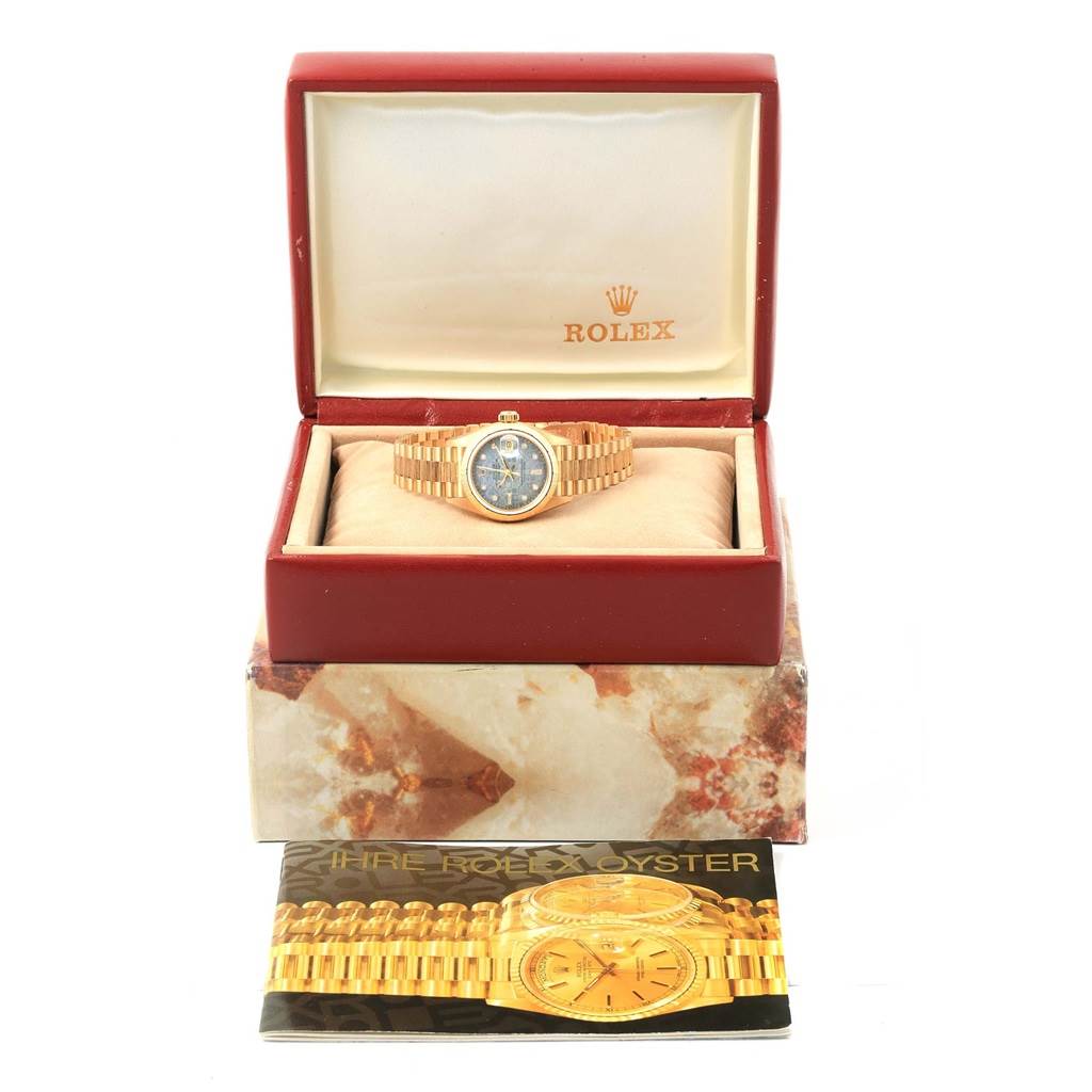 The Rolex Datejust 69278 Women's Yellow Gold Mother of Pearl Dial 69278 Women's Yellow Gold Mother of Pearl Dial watch is shown in an open box, facing forward, alongside its user manual.