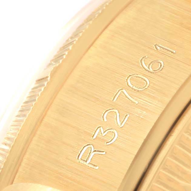 This is a close-up view of the serial number engraving on the Rolex Datejust 69278 Women's Yellow Gold Mother of Pearl Dial 69278 Women's Yellow Gold Mother of Pearl Dial model's gold watch casing.