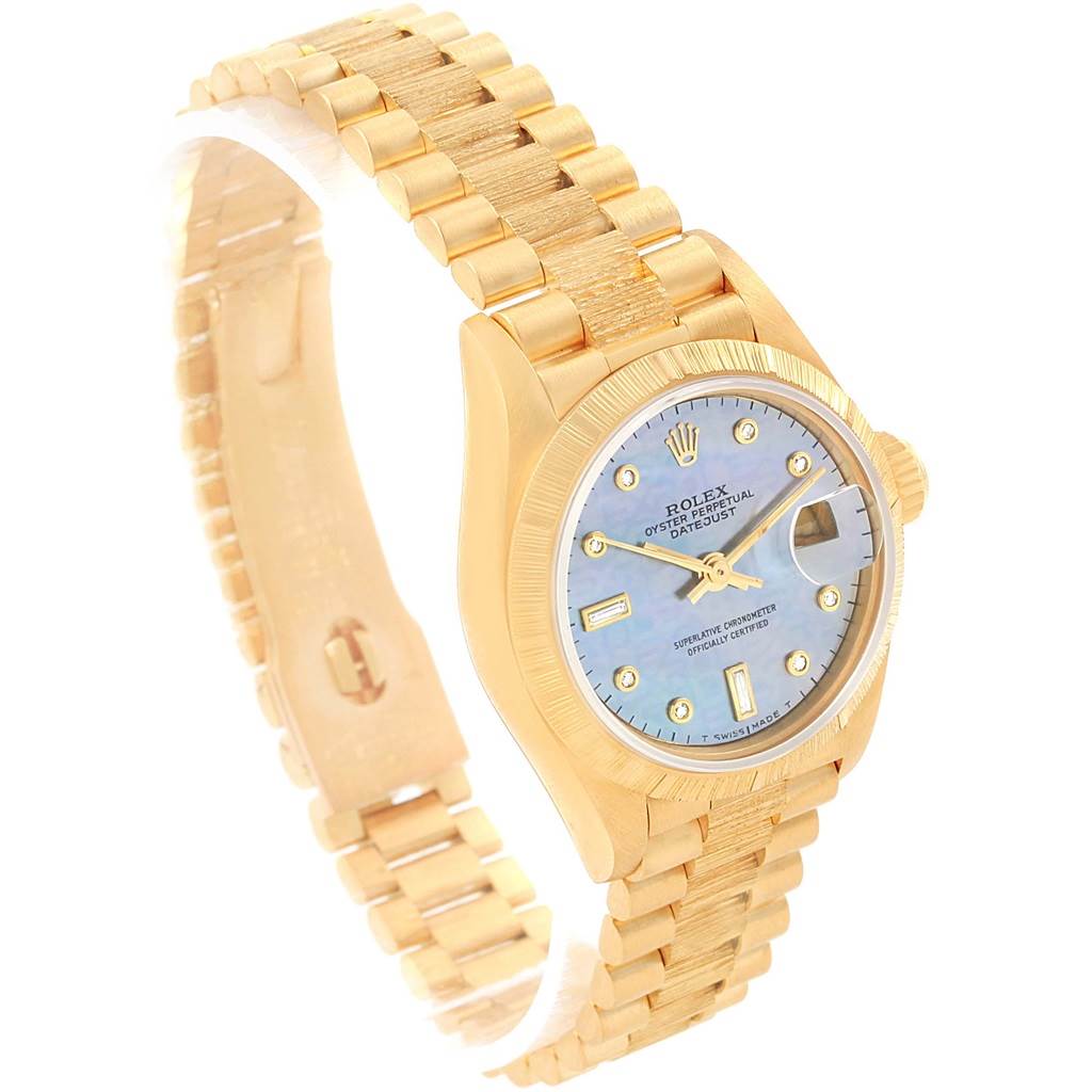 The image shows a side angle of a Rolex Datejust 69278 Women's Yellow Gold Mother of Pearl Dial 69278 Women's Yellow Gold Mother of Pearl Dial watch, highlighting its bracelet, case, dial, and bezel.