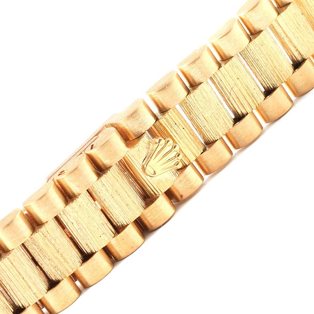 This image shows a close-up of the gold bracelet of a Rolex Datejust 69278 Women's Yellow Gold Mother of Pearl Dial 69278 Women's Yellow Gold Mother of Pearl Dial watch, highlighting the clasp with the Rolex logo.