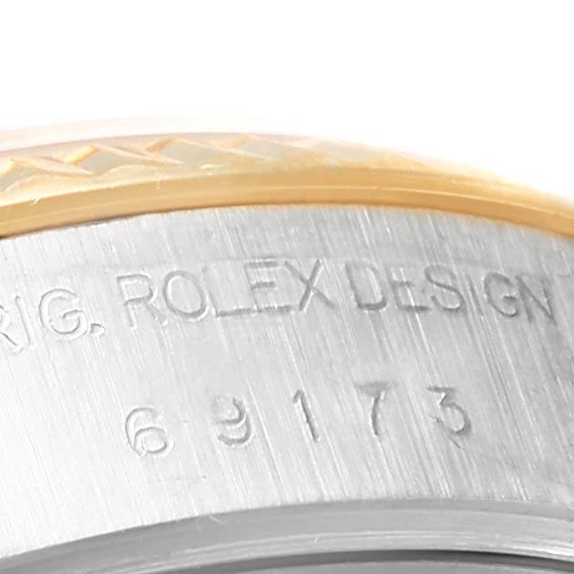 This image shows a close-up of the side of a Rolex Datejust 69173 Women's Stainless Steel Champagne Dial 69173 Women's Stainless Steel Champagne Dial watch case, highlighting the engraved model number.