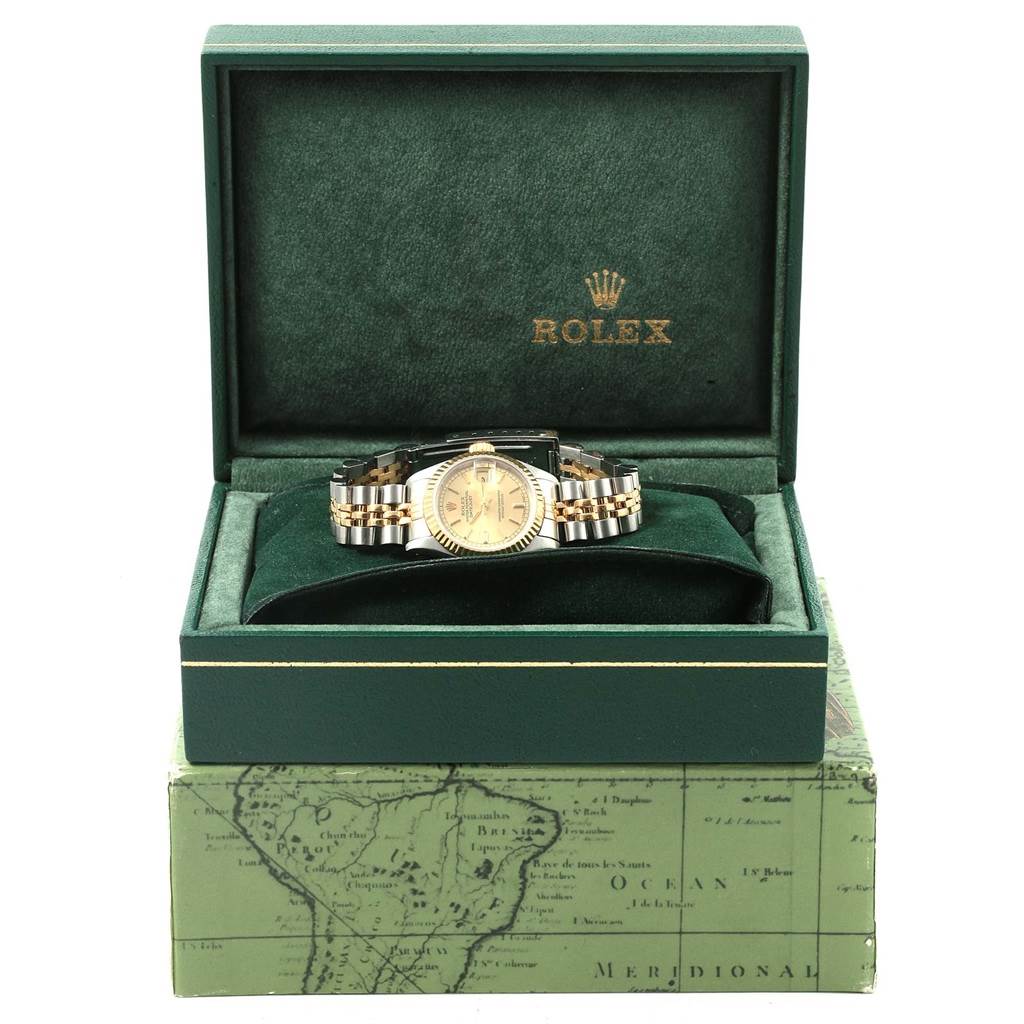 The Rolex Datejust 69173 Women's Stainless Steel Champagne Dial 69173 Women's Stainless Steel Champagne Dial watch is shown from the front, displayed in an open green box with the brand logo above.