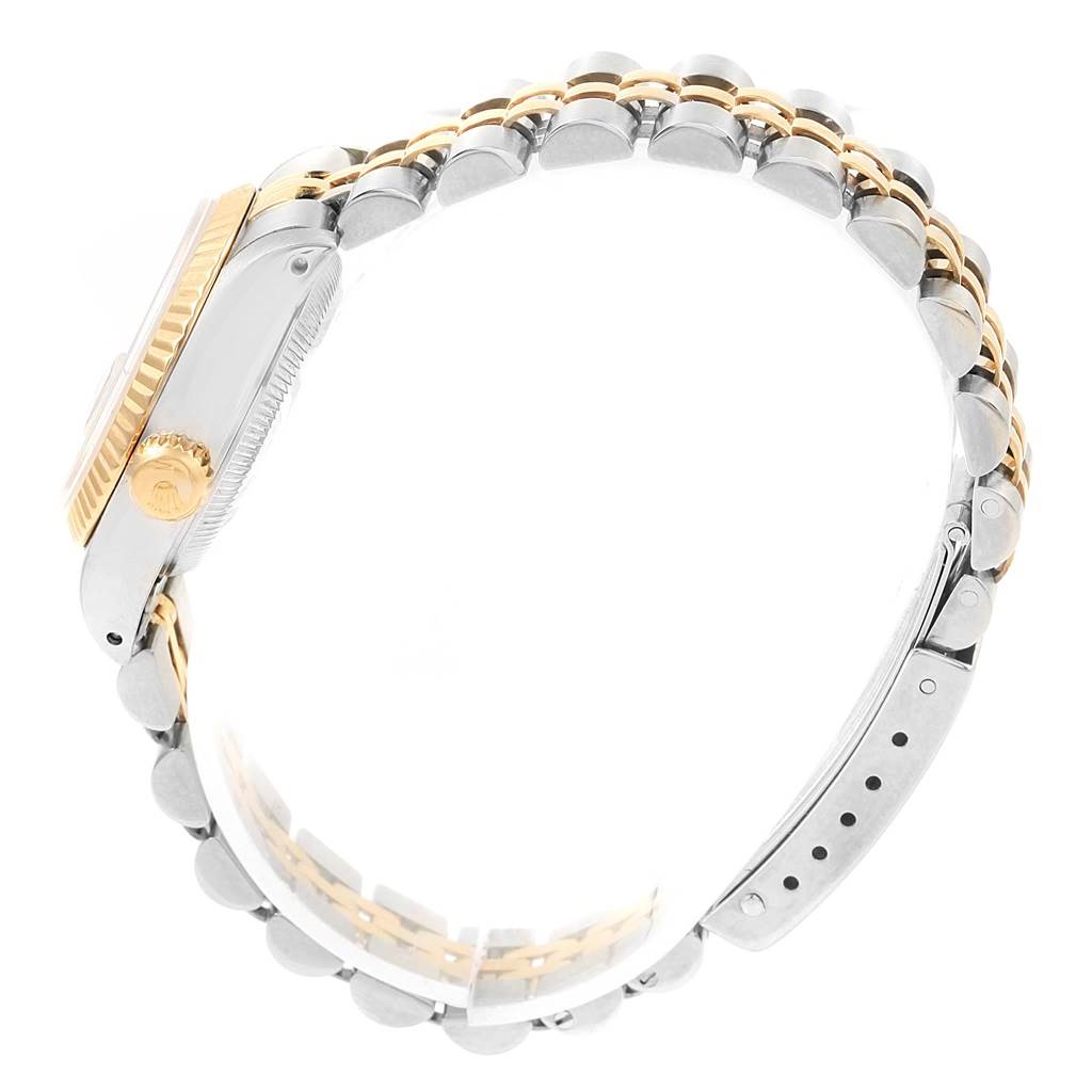 The image shows the side view of a Rolex Datejust 69173 Women's Stainless Steel Champagne Dial 69173 Women's Stainless Steel Champagne Dial watch, highlighting the crown, fluted bezel, and two-tone jubilee bracelet.