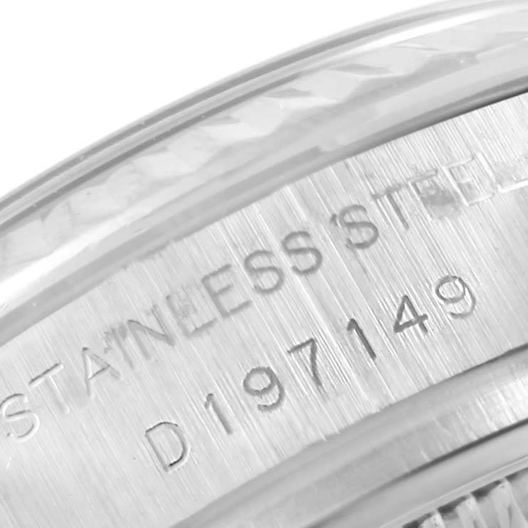 This close-up image of a Rolex Datejust 179174 Women's Stainless Steel Mother of Pearl Dial 179174 Women's Stainless Steel Mother of Pearl Dial watch shows part of the caseback, highlighting the stainless steel engraving and serial number.