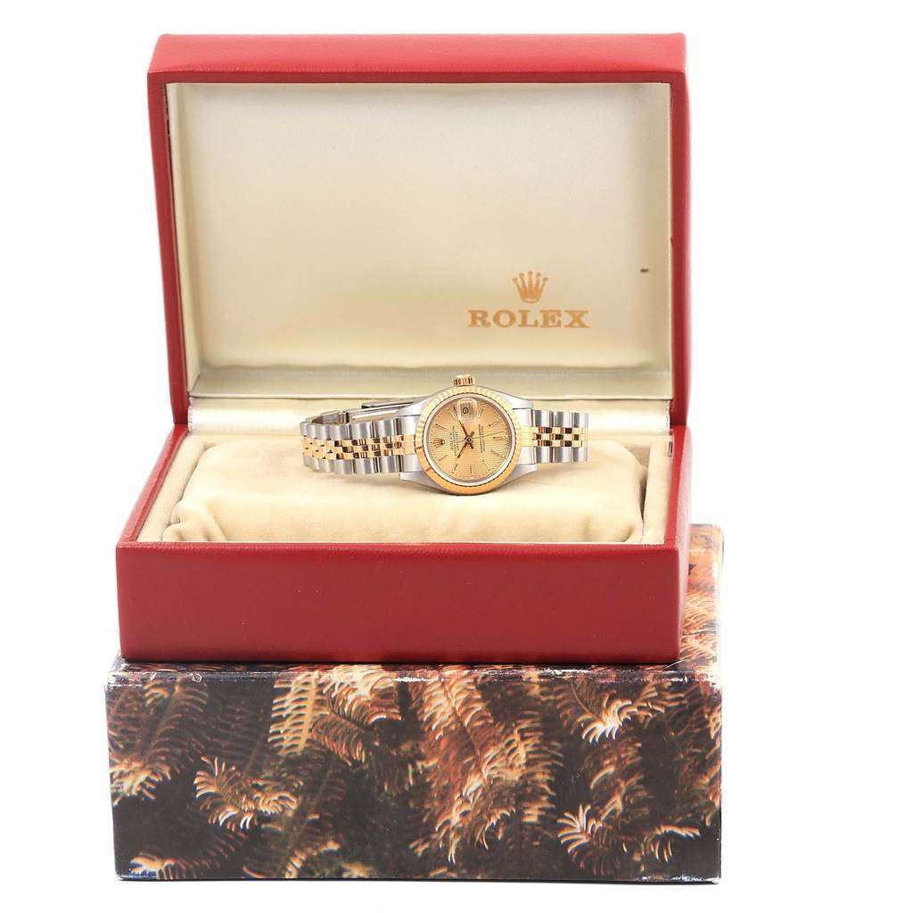 The Rolex Datejust 69173 Women's Stainless Steel Champagne Dial 69173 Women's Stainless Steel Champagne Dial watch is shown front and center in its open box, displaying the dial, bezel, and bracelet.