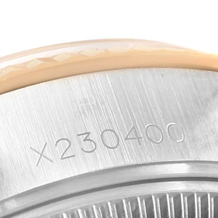 The image shows a close-up angle of the serial number on the case back of a Rolex Datejust 69173 Women's Stainless Steel Champagne Dial 69173 Women's Stainless Steel Champagne Dial watch.