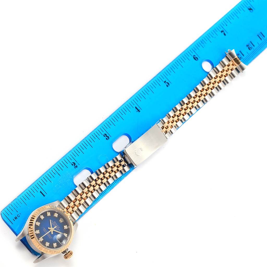 The image shows a Rolex Datejust 69173 Women's Stainless Steel Blue Dial 69173 Women's Stainless Steel Blue Dial watch laid flat with its face, bracelet, and clasp visible, alongside a blue ruler for measurement.