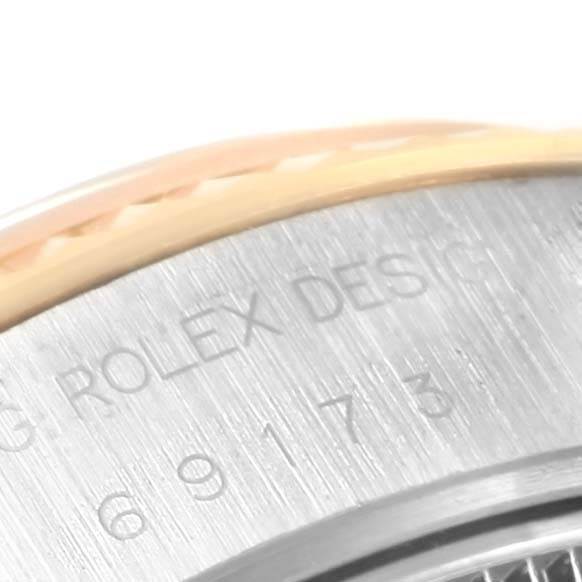 This close-up image of a Rolex Datejust 69173 Women's Stainless Steel Blue Dial 69173 Women's Stainless Steel Blue Dial watch shows the serial number and a portion of the fluted bezel.