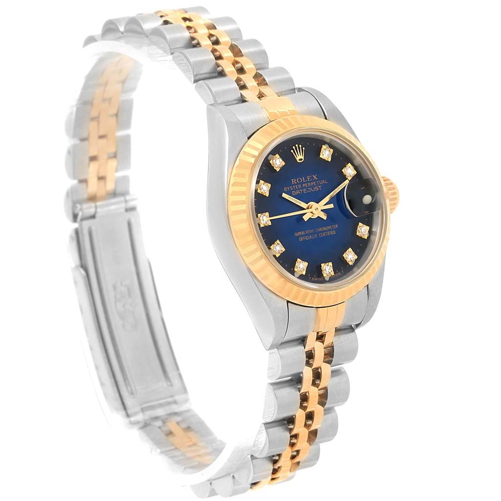 The Rolex Datejust 69173 Women's Stainless Steel Blue Dial 69173 Women's Stainless Steel Blue Dial watch is shown at a slight angle, highlighting its two-tone bracelet, blue dial, and gold fluted bezel.