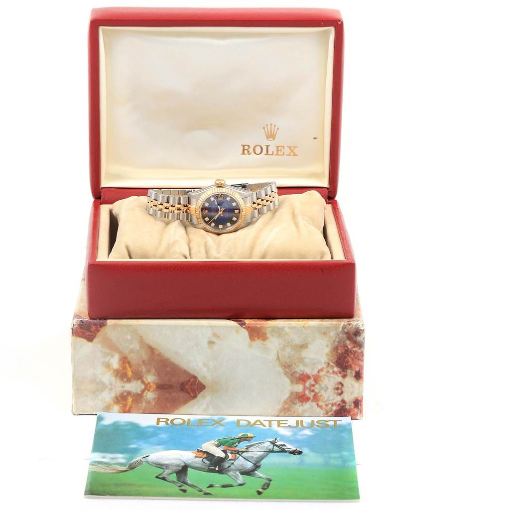 The image shows a Rolex Datejust 69173 Women's Stainless Steel Blue Dial 69173 Women's Stainless Steel Blue Dial watch in its open box along with a brochure placed in front of the box.