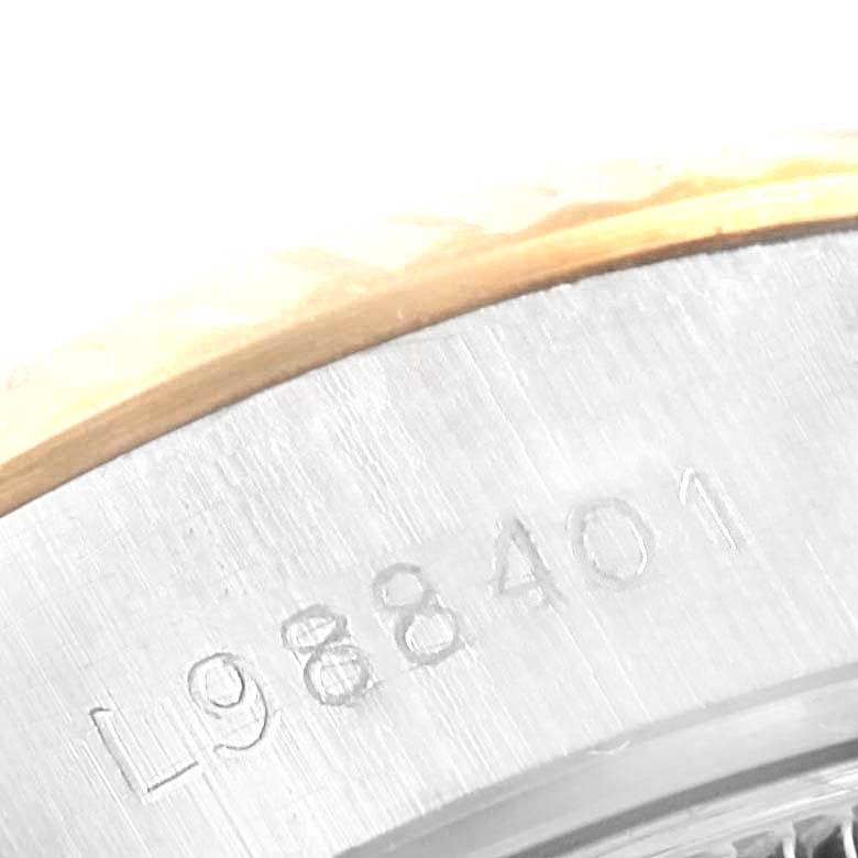 The image shows a close-up of the serial number engraved on the side of a Rolex Datejust 69173 Women's Stainless Steel Champagne Dial 69173 Women's Stainless Steel Champagne Dial watch case.