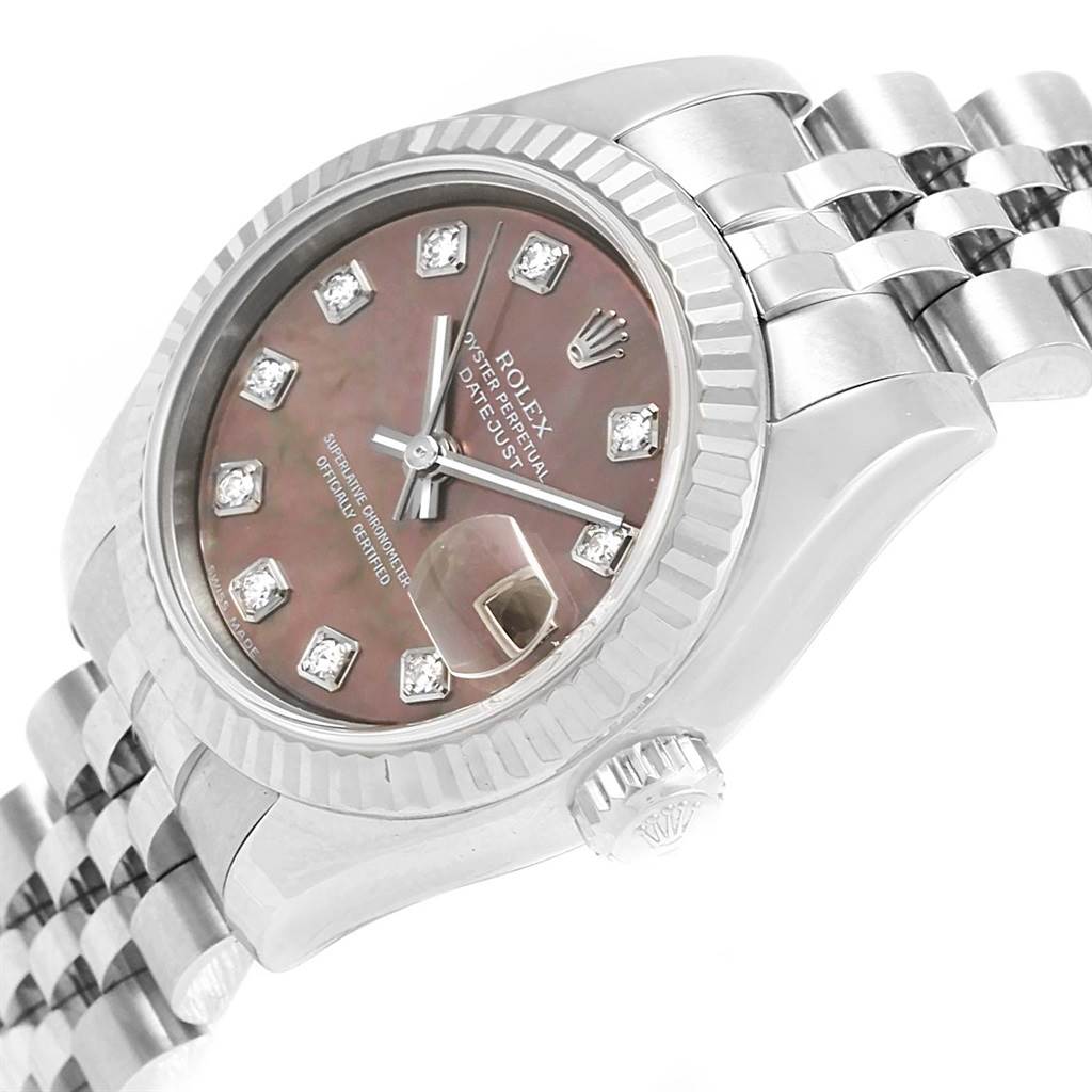 The image shows the Rolex Datejust 179174 Women's Stainless Steel Mother of Pearl Dial 179174 Women's Stainless Steel Mother of Pearl Dial watch at an angle highlighting the face, bezel, crown, and part of the bracelet.