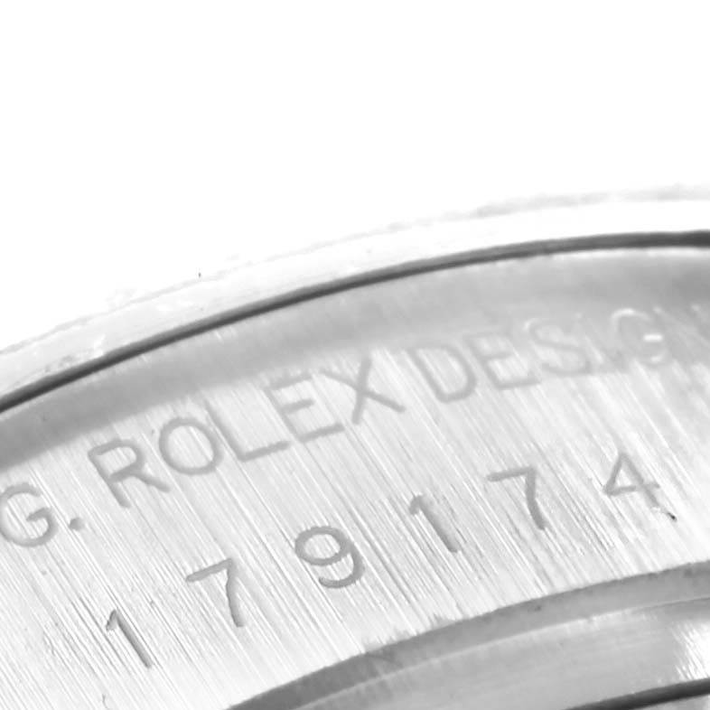 The image shows a close-up of the engraved serial number and "Rolex Design" text on the case of a Rolex Datejust 179174 Women's Stainless Steel Mother of Pearl Dial 179174 Women's Stainless Steel Mother of Pearl Dial watch.