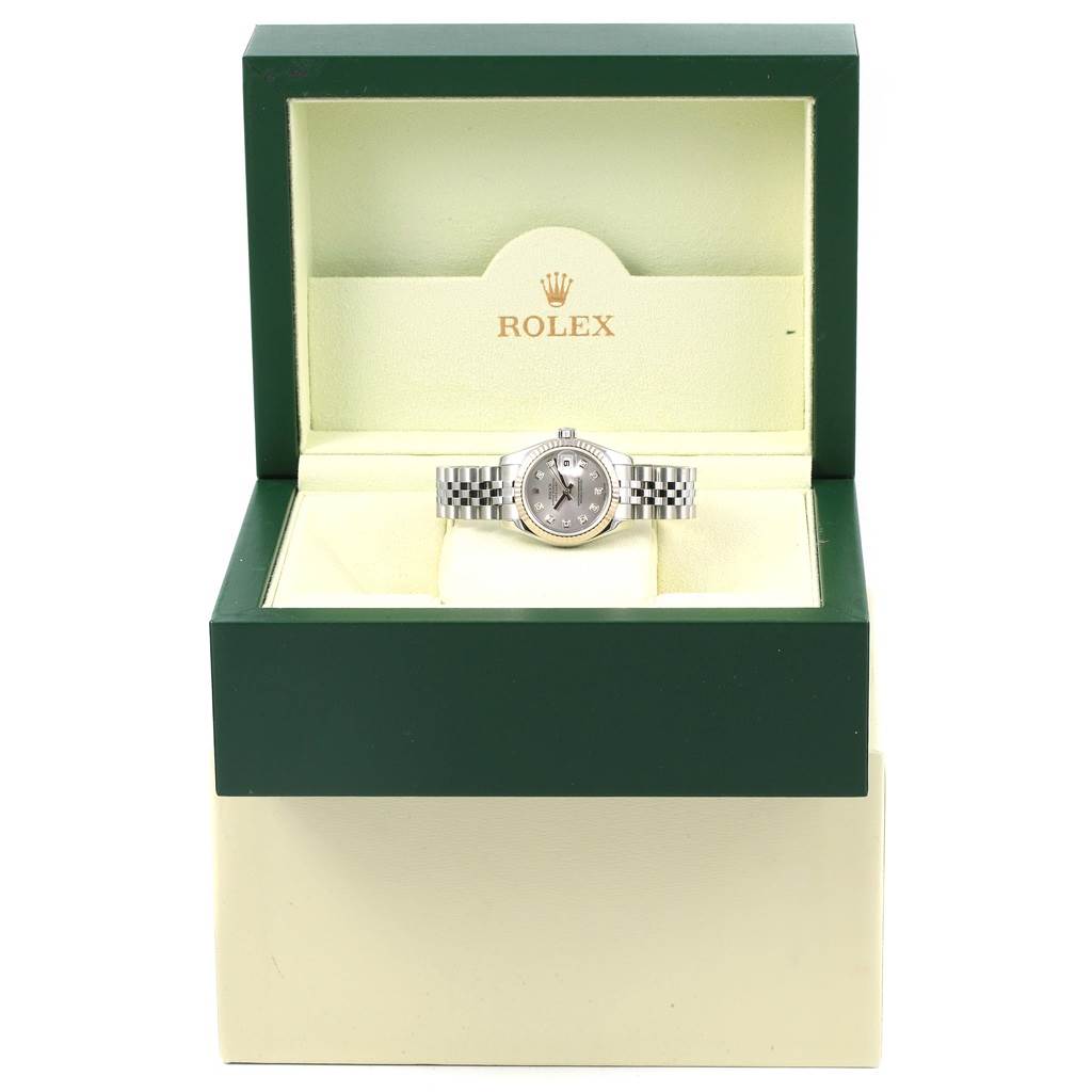 The image shows a Rolex Datejust 179174 Women's Stainless Steel Silver Dial 179174 Women's Stainless Steel Silver Dial watch, displayed front-facing in an open green and beige case.