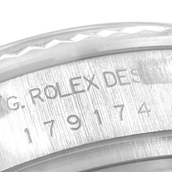 This image shows a close-up of the engraving and part of the bezel of a Rolex Datejust 179174 Women's Stainless Steel Silver Dial 179174 Women's Stainless Steel Silver Dial watch.