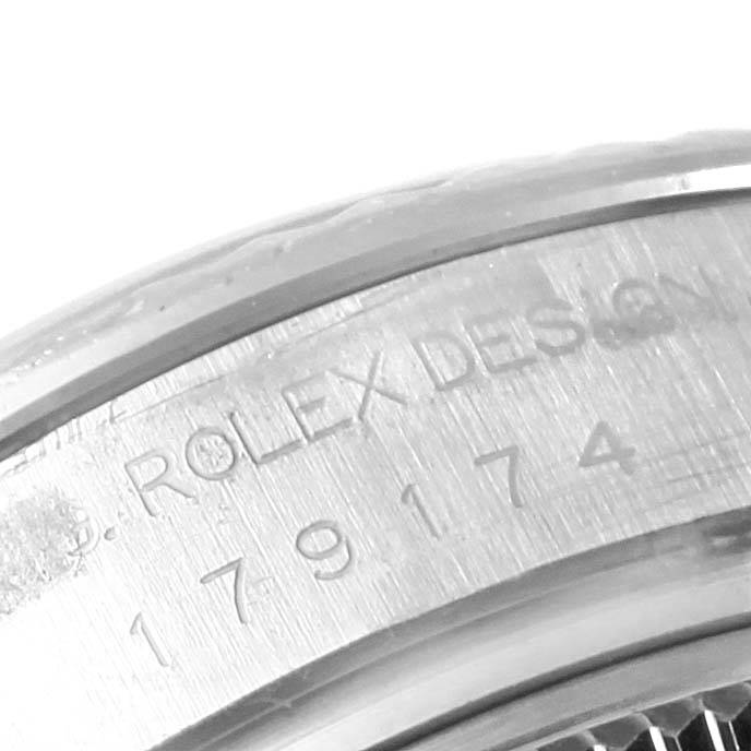 The image shows a close-up of the engraving on the bezel of a Rolex Datejust 179174 Women's Stainless Steel Mother of Pearl Dial 179174 Women's Stainless Steel Mother of Pearl Dial watch.