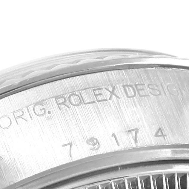 This close-up image shows the side of the watch case with engraved text detailing the Rolex Datejust 79174 Women
s Stainless Steel Pink Dial 79174 Women
s Stainless Steel Pink Dial model.