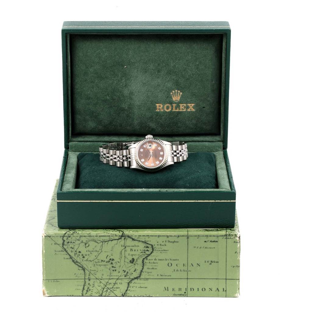 The image shows a Rolex Datejust 79174 Women
s Stainless Steel Pink Dial 79174 Women
s Stainless Steel Pink Dial watch in a green Rolex box, with the dial, bezel, and bracelet clearly visible.