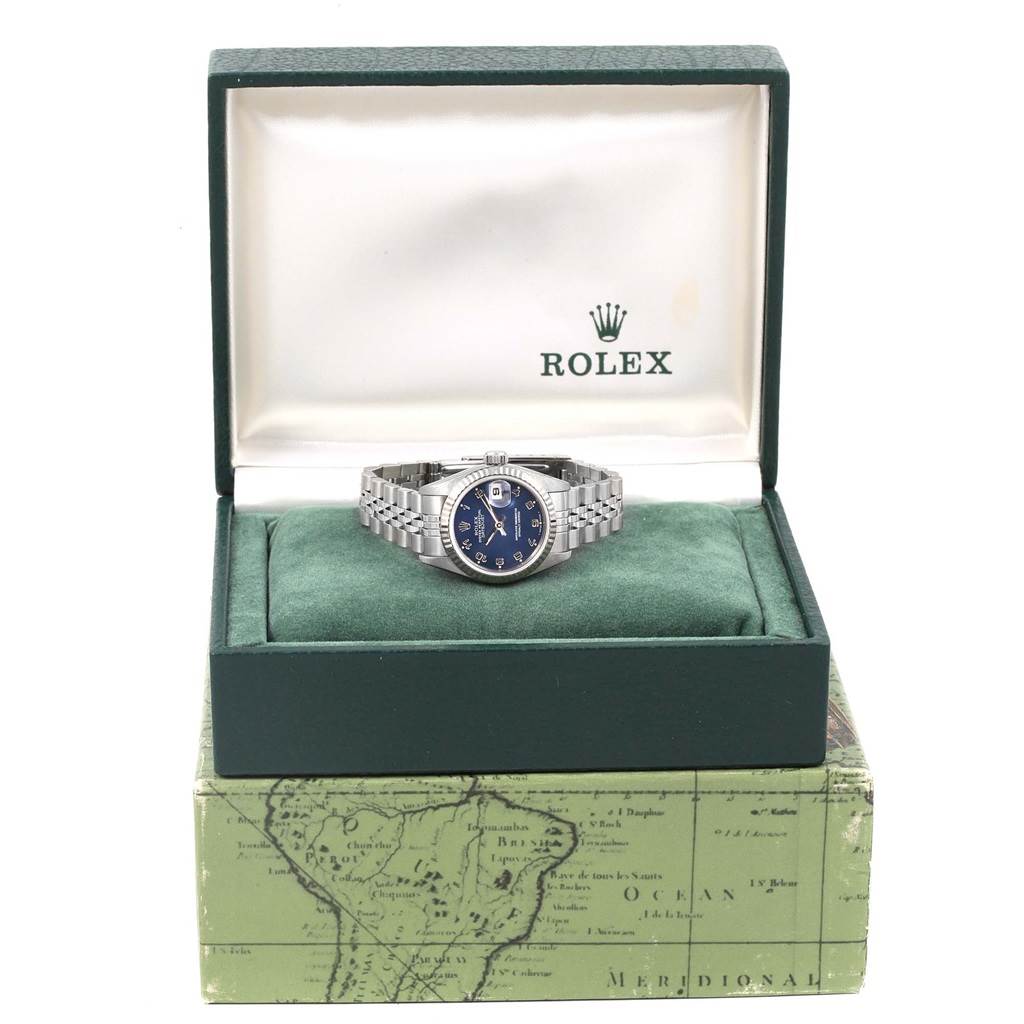 The Rolex Datejust 69174 Women's Stainless Steel Blue Dial 69174 Women's Stainless Steel Blue Dial watch is displayed frontally in an open box, showing its face and bracelet.