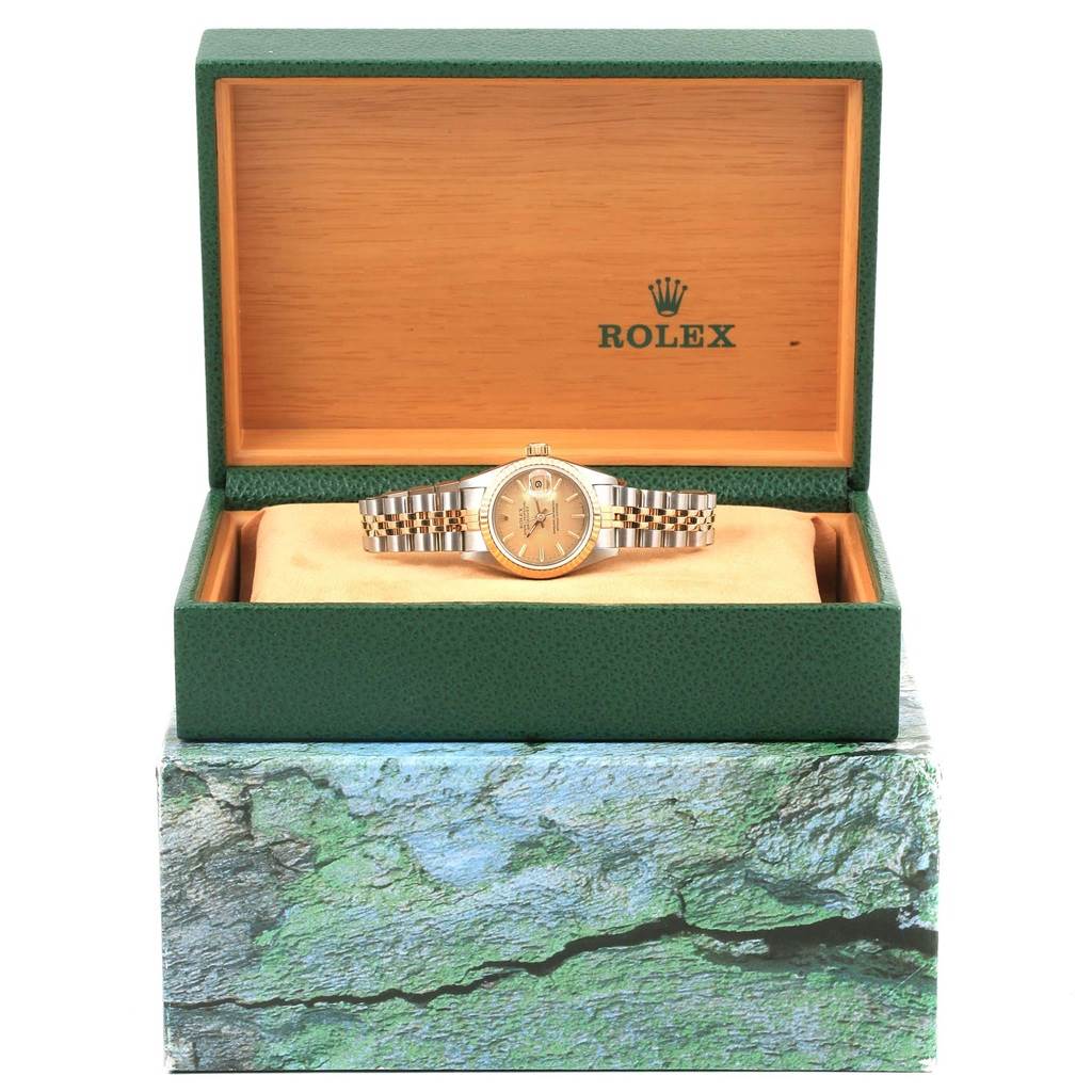 The Rolex 69173 Men's Stainless Steel Champagne Dial 69173 Men's Stainless Steel Champagne Dial Datejust Steel Yellow Gold Champagne Linen Dial Ladies Watch 69173 is shown front-facing in its open green and wooden box.