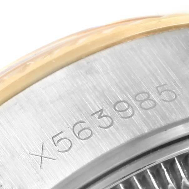 The image focuses on the serial number engraving on the side of the Rolex 69173 Men's Stainless Steel Champagne Dial 69173 Men's Stainless Steel Champagne Dial Datejust Steel Yellow Gold Champagne Linen Dial Ladies Watch 69173.