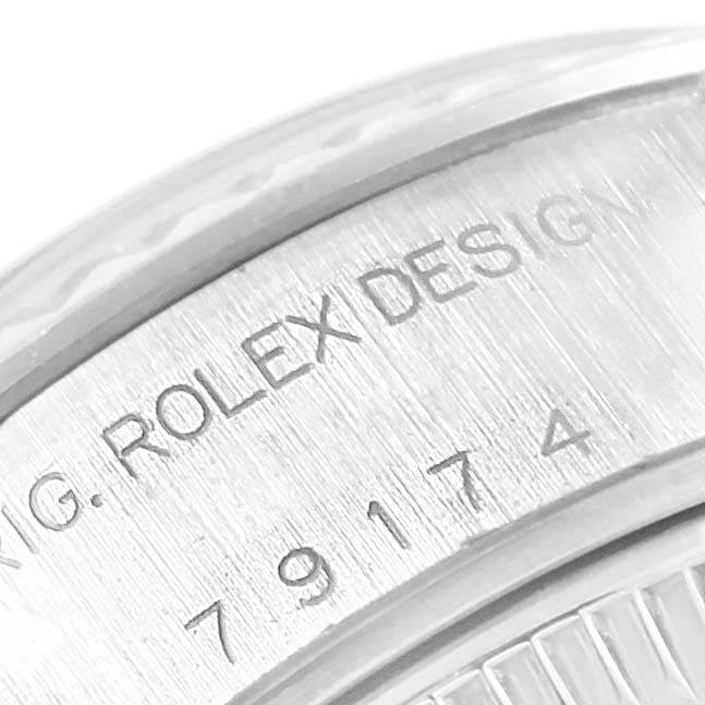 This image shows a close-up of the engraved serial number on the casing of a Rolex Datejust 79174 Women's Stainless Steel Silver Dial 79174 Women's Stainless Steel Silver Dial watch.