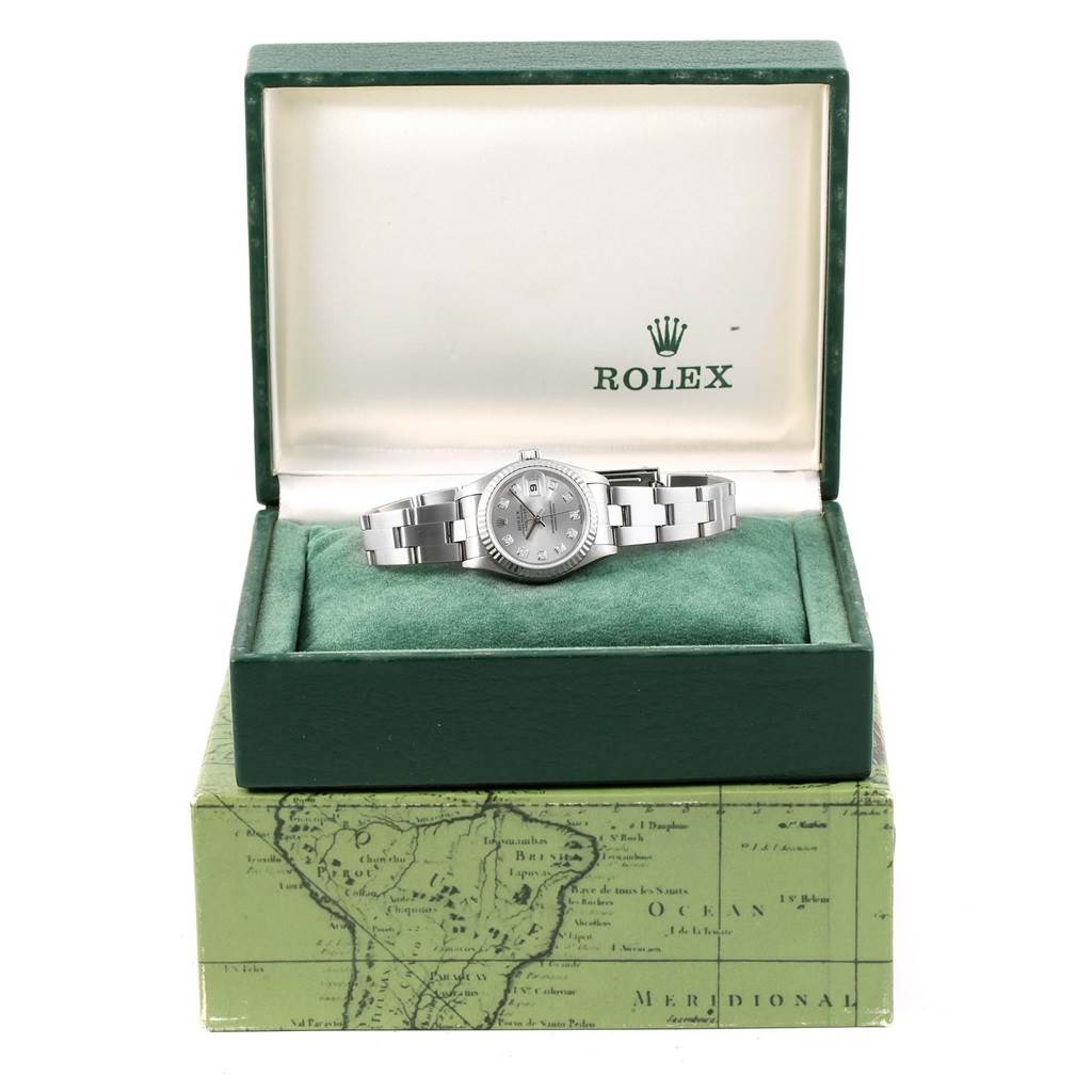 The Rolex Datejust 79174 Women's Stainless Steel Silver Dial 79174 Women's Stainless Steel Silver Dial watch is displayed front-on in an open green box with the brand logo visible inside the lid.