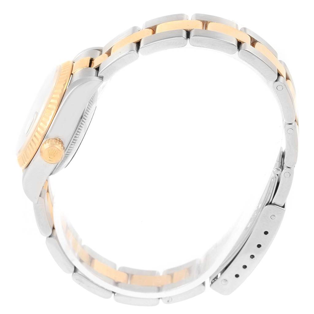 This side view of the Rolex Datejust 69173 Women's Stainless Steel Champagne Dial 69173 Women's Stainless Steel Champagne Dial watch highlights the two-tone bracelet, bezel, and crown.