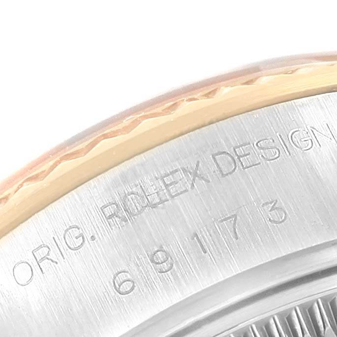 A close-up of the bezel and part of the case back of a Rolex Datejust 69173 Women's Stainless Steel Champagne Dial 69173 Women's Stainless Steel Champagne Dial, showing the engraved model number and "ROLEX DESIGN" text.