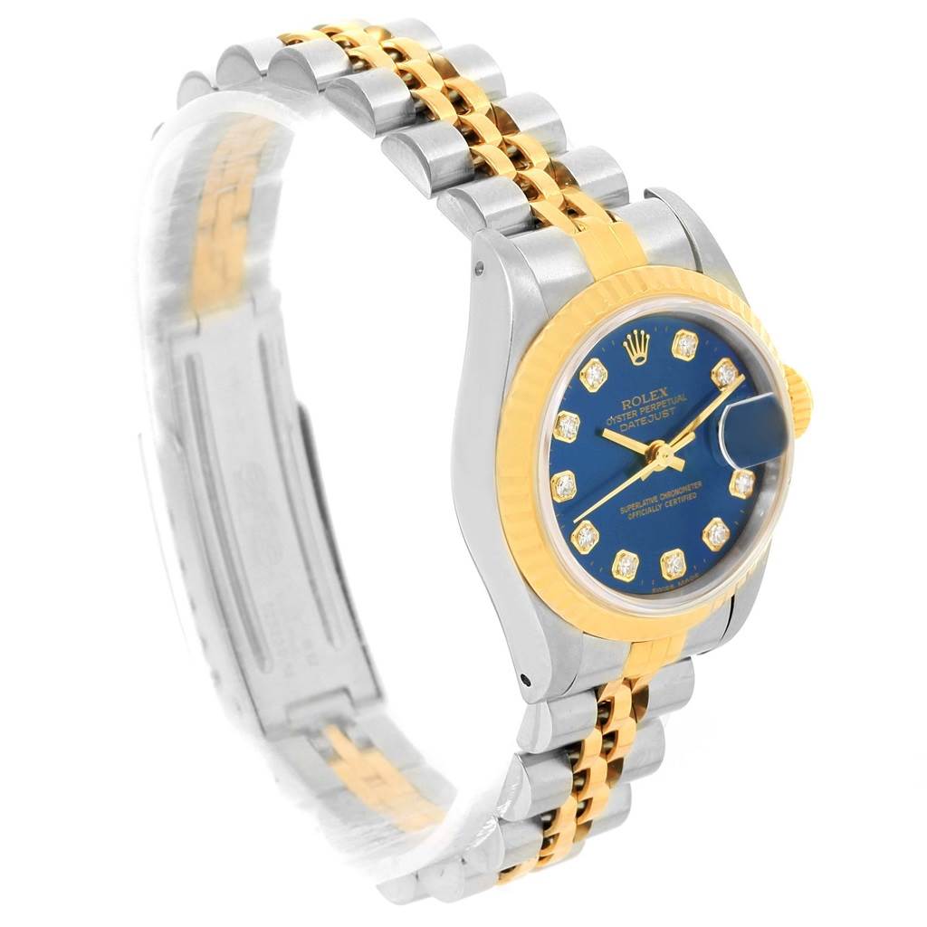 The image shows a side-angle view of a Rolex Datejust 69173 Women's Steel and Gold (two tone) Blue Dial 69173 Women's Steel and Gold (two tone) Blue Dial watch, detailing its two-tone bracelet, bezel, and blue dial with diamond hour markers.