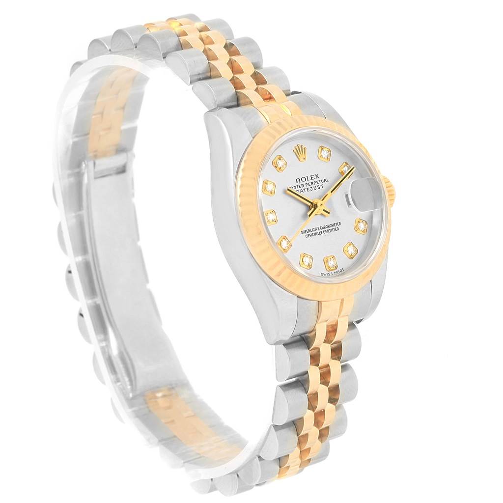 The image shows a Rolex Datejust 179173 Women's Steel and Gold (two tone) Silver Dial 179173 Women's Steel and Gold (two tone) Silver Dial watch from a side angle, displaying the face, bezel, and bracelet.