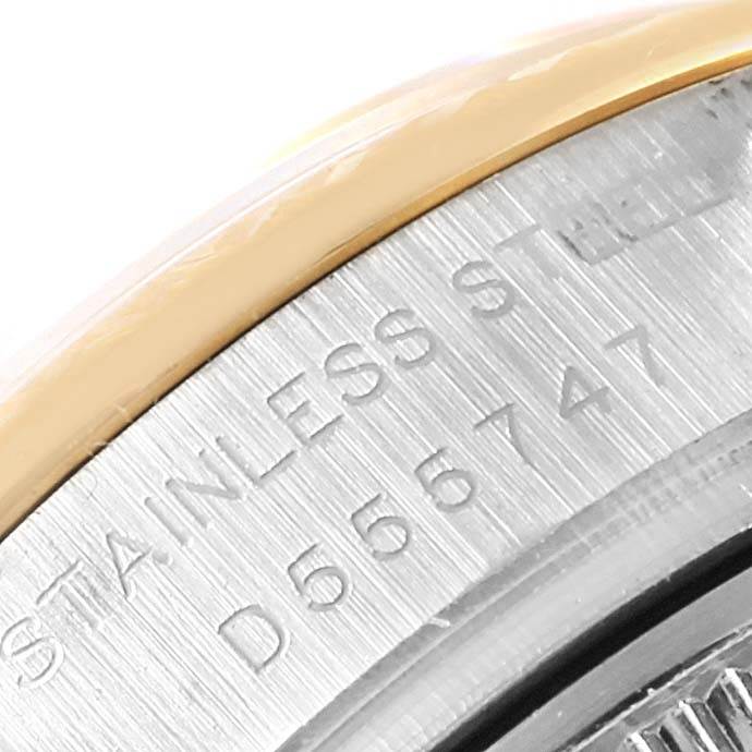 The image shows a close-up angle of the case back and part of the bezel of a Rolex Datejust 179173 Women's Steel and Gold (two tone) Silver Dial 179173 Women's Steel and Gold (two tone) Silver Dial watch, featuring stainless steel text.