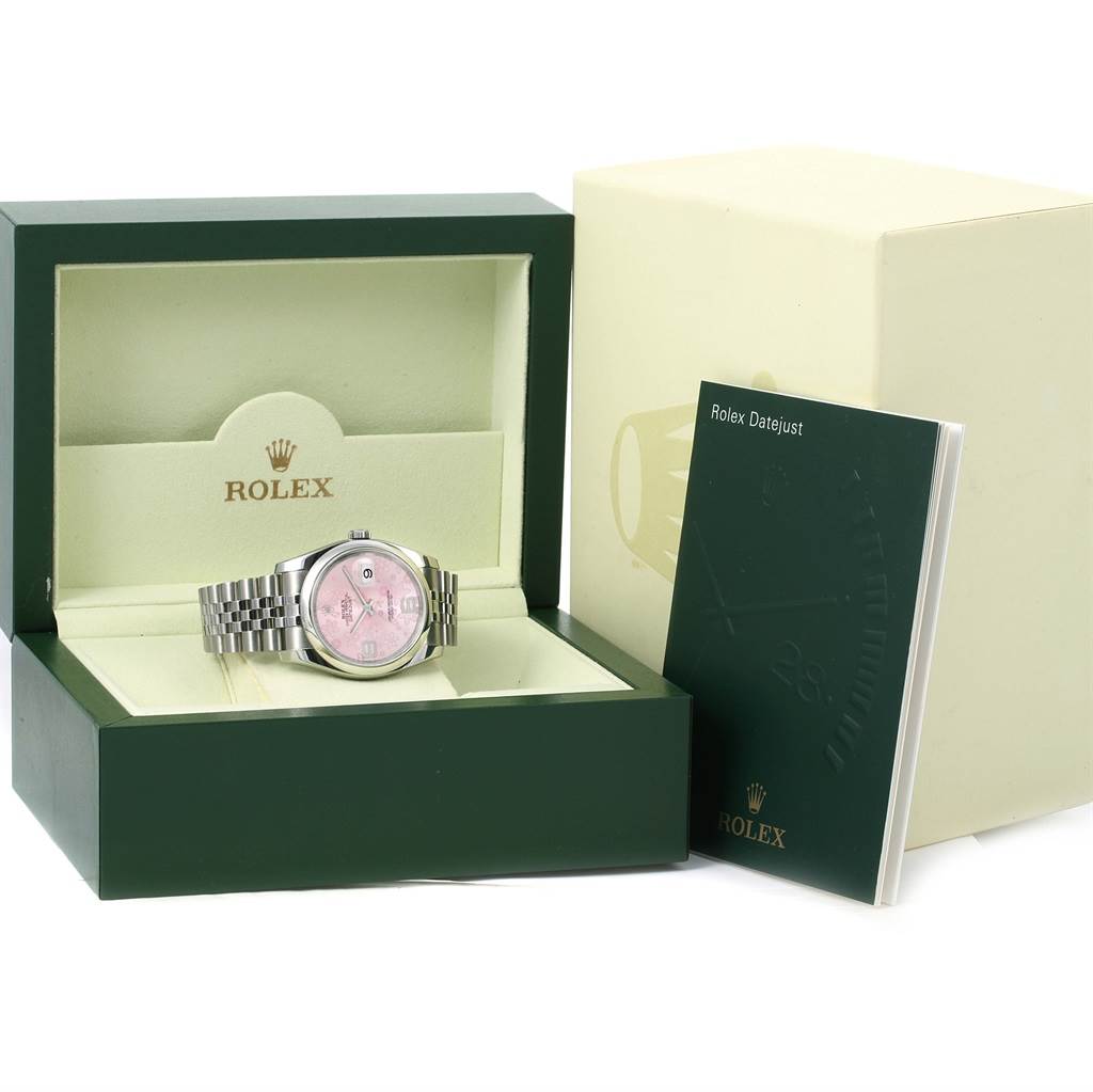 The Rolex Datejust 116200 Women's Stainless Steel Pink Dial 116200 Women's Stainless Steel Pink Dial watch is shown from the front in its open box, alongside its manual and outer box.